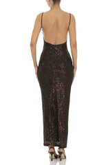 Woman wearing a floor-length dark sequined dress with spaghetti straps and a sweetheart neckline, back view