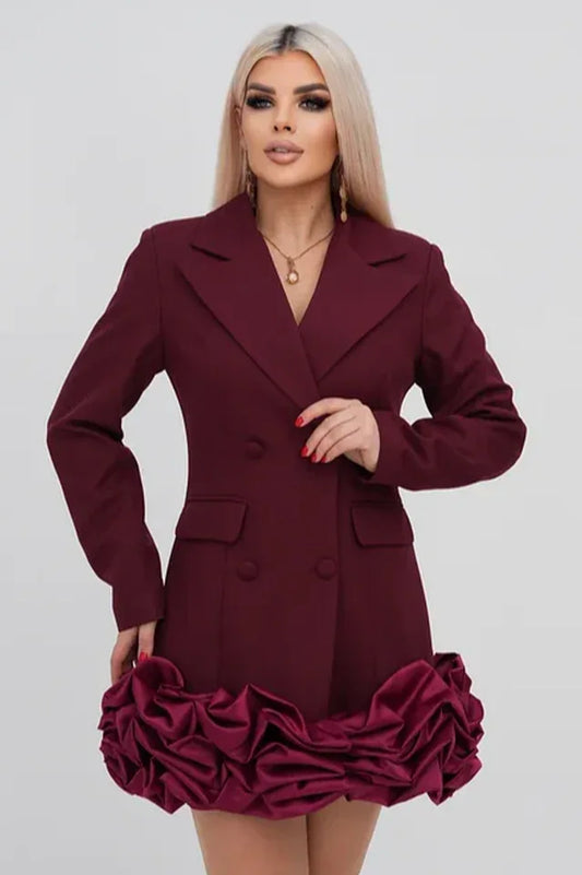 Woman wearing a maroon double-breasted blazer dress with a ruffled hem