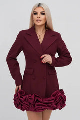 Woman wearing a maroon double-breasted blazer dress with a ruffled hem