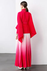 Back view of a model wearing a bright pink wrap top and white to bright pink ombre pleated maxi skirt.