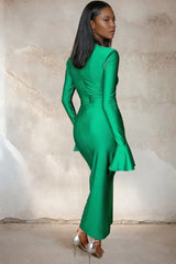 Back view of a woman in a long green satin dress with flared sleeves