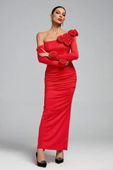 Woman in a red one-shoulder gown with rose embellishments and a ruched skirt.