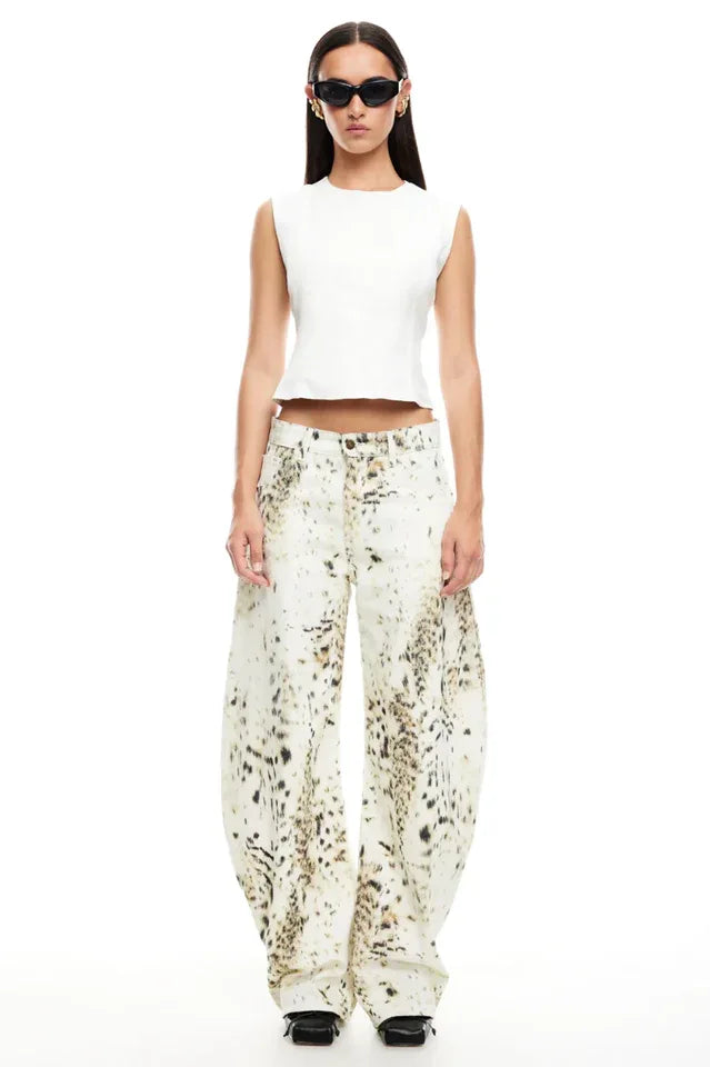 Model wearing a white sleeveless top and wide-leg printed pants, front view.