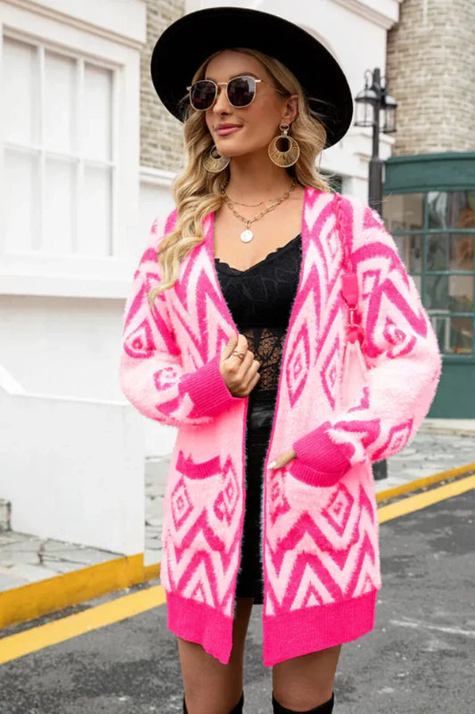 Woman wearing a pink and white geometric pattern fluffy knit longline cardigan