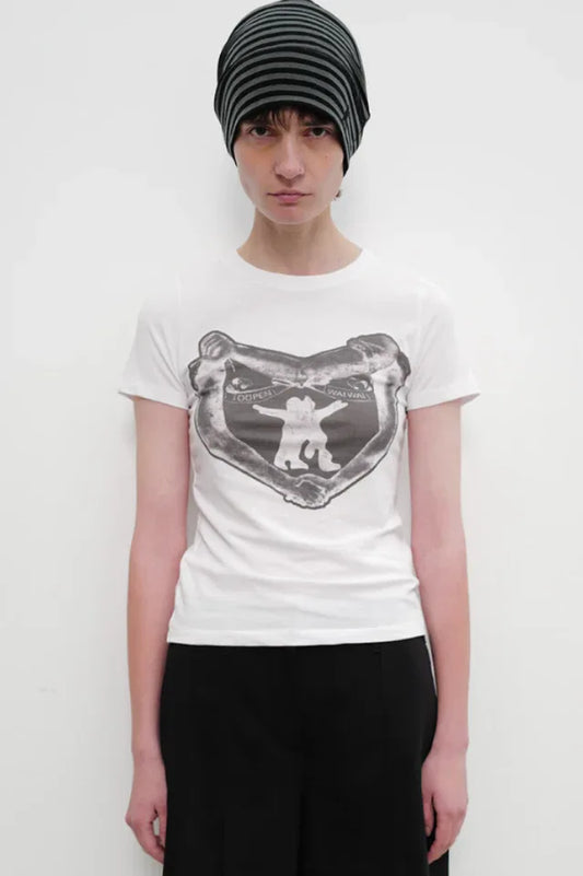 Model wearing a white crew neck t-shirt with a black and white graphic print on the chest and a black and grey striped beanie.