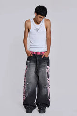 Model wearing wide leg jeans with tribal print and a white tank top