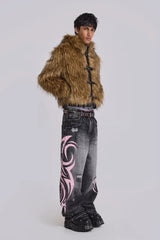Model wearing wide leg jeans with tribal print, a brown faux fur jacket, and a studded belt