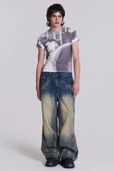 Male model wearing wide leg jeans with a graphic t-shirt.