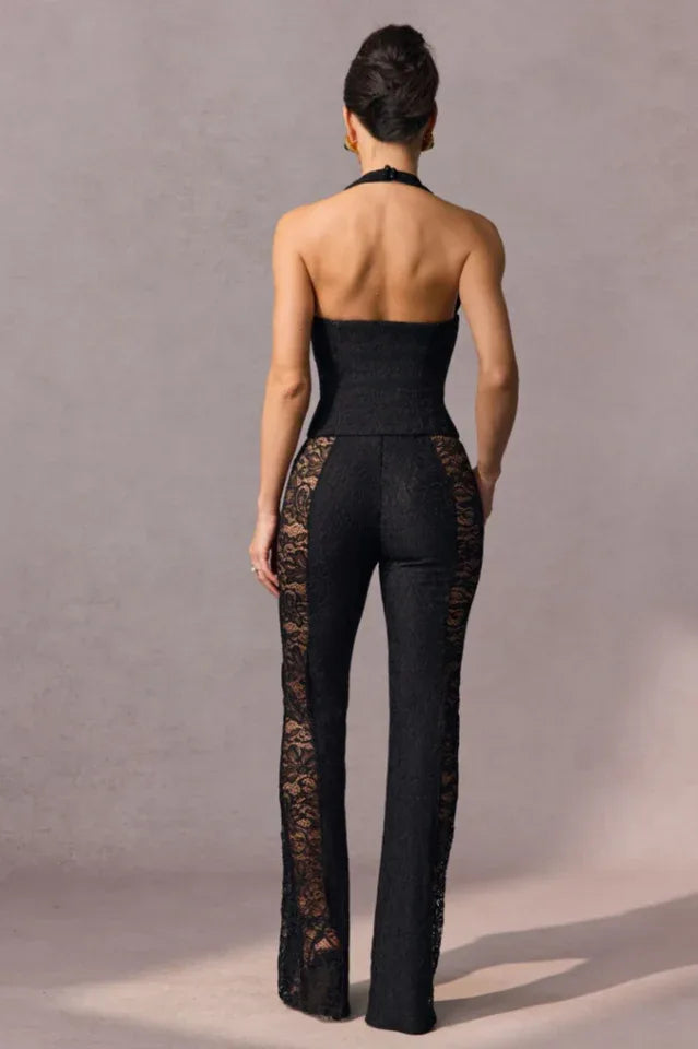 Rear view of a woman wearing a black lace halter top and flared pants with lace detailing