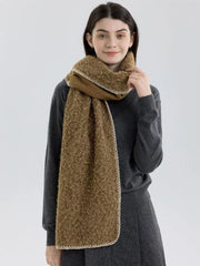 Woman wearing a brown fuzzy knit scarf and dark grey sweater