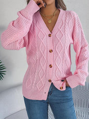 front view of a woman adjusting her pink cable knit cardigan