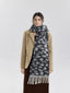 Front view of a woman in a tan blazer, brown skirt, and leopard print scarf