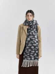 Front view of a woman in a tan blazer, brown skirt, and leopard print scarf
