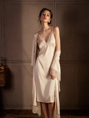 Full-length view of a woman in a cream satin slip dress with lace trim and a matching robe, standing.