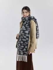 Side profile of a woman wearing a tan blazer and a leopard print scarf