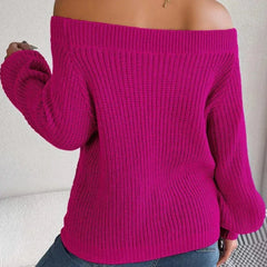 Back view of a woman wearing a fuchsia off-the-shoulder knit sweater.