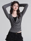 Model wearing a grey long-sleeved top with a draped neckline and a black underlayer.