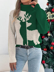 Front view of a woman wearing a green and cream knit sweater with a reindeer graphic and a turtleneck, styled with jeans and a belt.