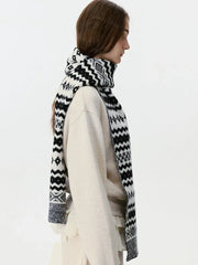 Woman from the side wearing a black and white Fair Isle knit scarf