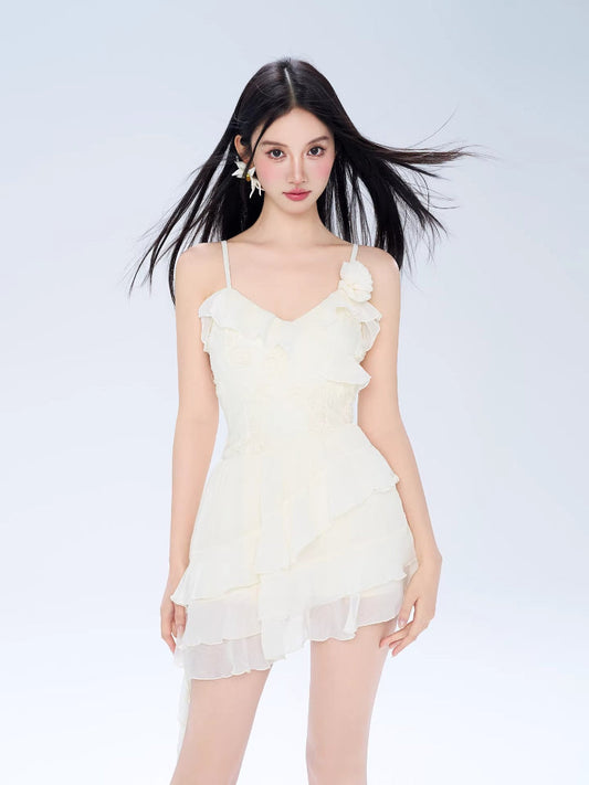 Model wearing a white ruffled mini dress with spaghetti straps and a layered skirt