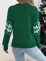 back view of woman wearing green snowflake print knit sweater