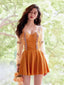 Woman in a mustard yellow one-piece swimsuit with sheer puff sleeves and embroidered trim, standing outdoors with a bouquet of roses.