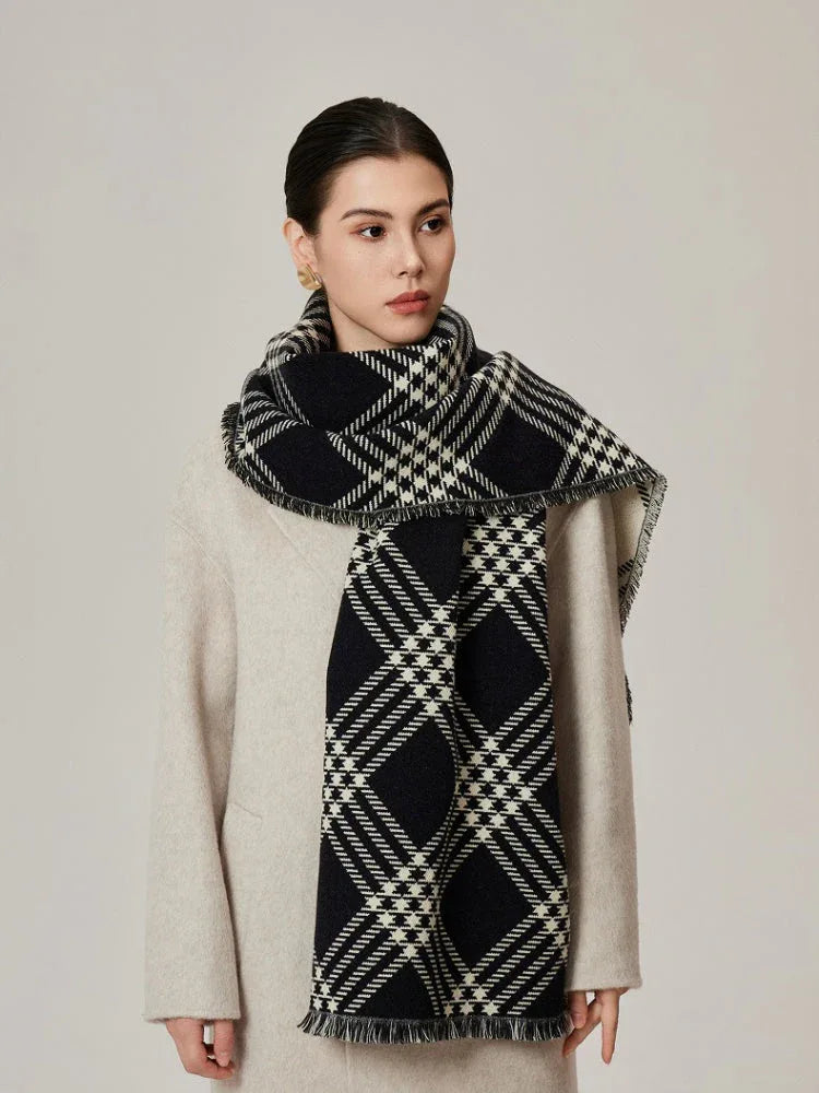 Woman in a cream coat with a black and white tartan scarf