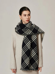 Woman in a cream coat with a black and white tartan scarf