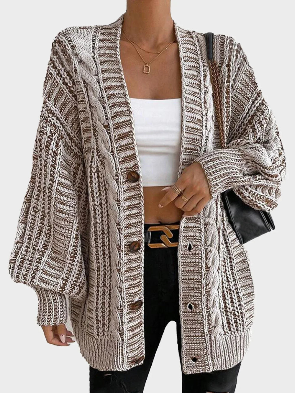 Close-up of the front of a brown and white striped oversized knit cardigan