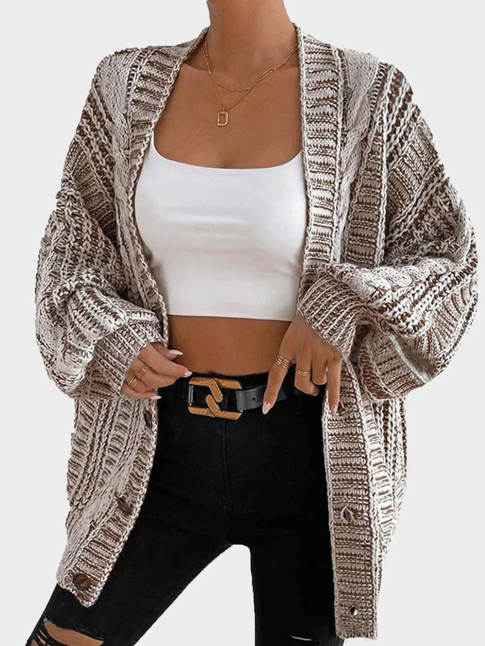 Front view of a woman in a brown and white striped knit cardigan
