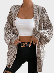 Front view of a woman in a brown and white striped knit cardigan