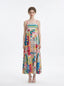 Woman wearing a colorful printed maxi dress with spaghetti straps, front view