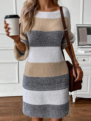 Woman holding a coffee cup while wearing a striped knit dress and a brown crossbody bag.