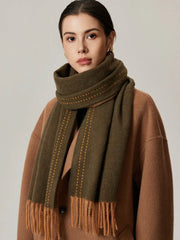 Close-up of a woman wearing a green scarf with orange detailing