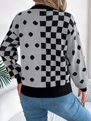 Back view of a woman wearing a gray and black checkerboard and polka dot knit sweater