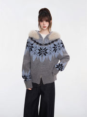 Close-up of a woman wearing a grey and blue Fair Isle knit zip-up cardigan with a faux fur trim hood
