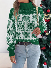 Woman wearing a green and white snowflake print turtleneck sweater and holding a handbag