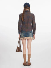Full-body back view of a woman wearing a plaid button-down shirt, denim mini skirt with faux fur trim, and a tie.
