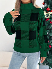 Woman in a green and black buffalo plaid turtleneck sweater posing with hand on hip