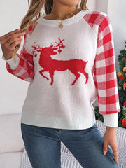 Woman touching her hair while wearing a white and red reindeer graphic knit sweater with gingham plaid sleeves.