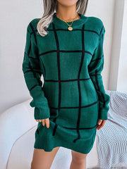 Woman wearing a green and black plaid knit sweater dress
