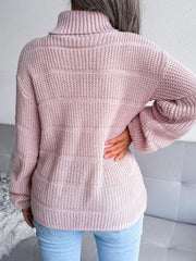 Back view of a woman wearing a pink knit turtleneck sweater with light blue jeans.