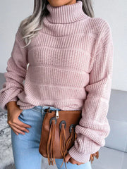 Close-up of a woman wearing a pink knit turtleneck sweater.