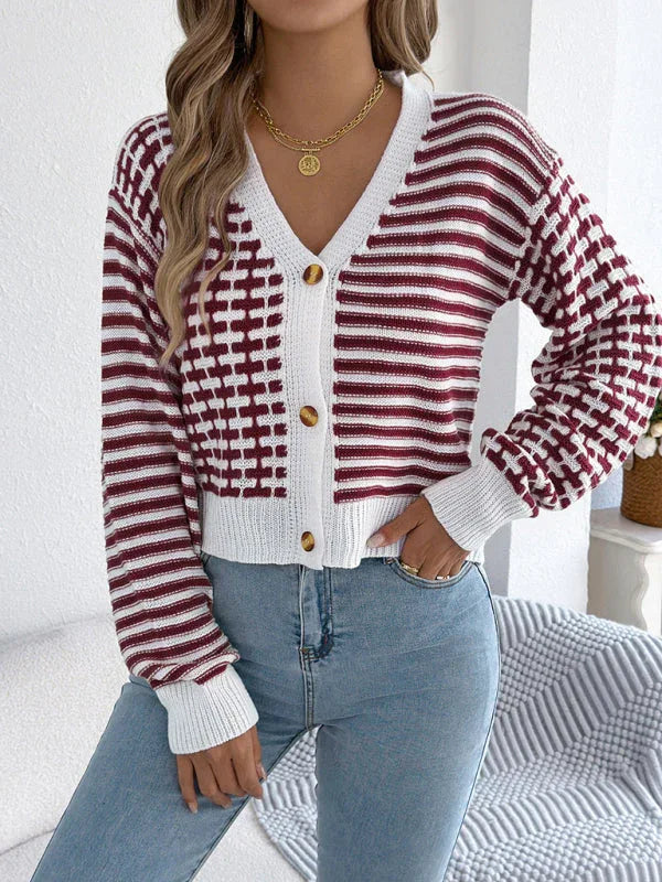 Close-up of a woman wearing a red and white striped and checkered knit cardigan