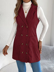 Woman in a burgundy corduroy sleeveless blazer, showing the button details.
