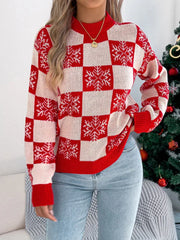 Close-up of a woman wearing a red and white checkered snowflake print knit sweater.