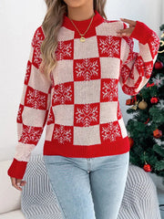 Woman wearing a red and white checkered snowflake print knit sweater with a mock neck and long sleeves.