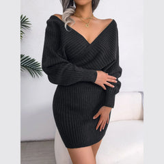 Woman wearing a charcoal ribbed knit V-neck mini dress with long sleeves and a wrap front.