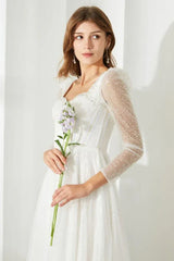 Side view of a woman in a white sequined dress, highlighting the design of the sleeves and neckline.