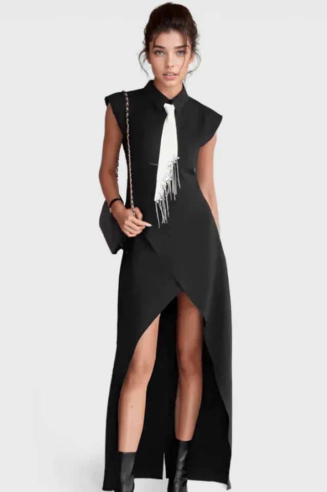 Woman wearing a black sleeveless maxi dress with a white tie detail and an asymmetrical hemline